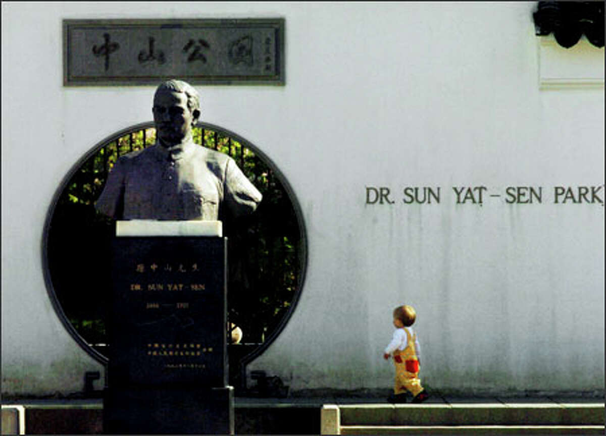 The bust of Dr. Sun Yat-Sen dominates the park adjacent to the Chinese Cultural Centre and Dr. Sun Yat-Sen garden in Vancouver, B.C.'s Chinatown.Larsen: Vancouver B.C.’s Chinatown is full of visual surprises. The small Asian child was a nice contrast to the bust on display.
