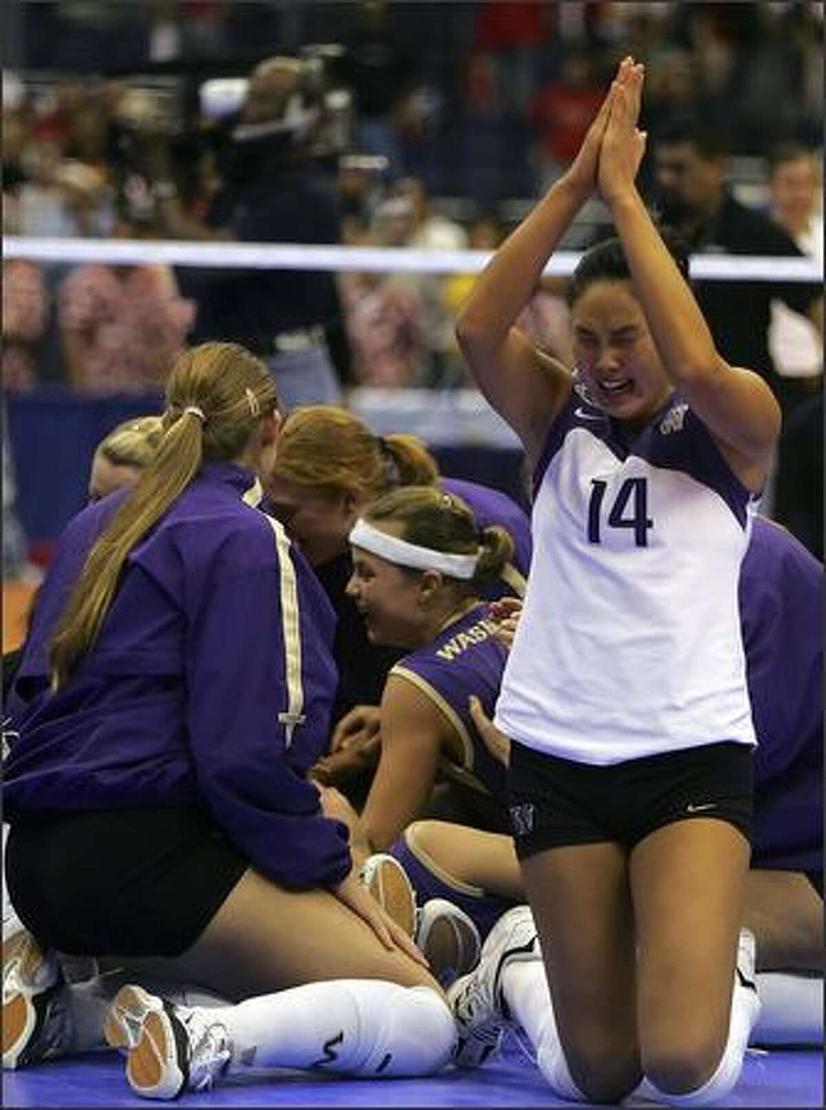 Candace Lee celebrates with teammates after winning the national volleyball title.