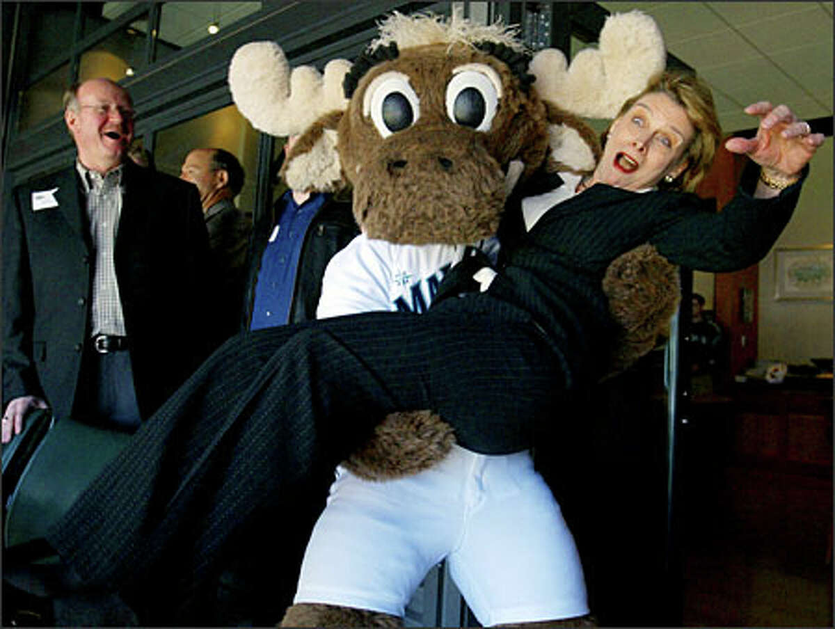 When the Mariner Moose asked Gregoire on Opening Day to put down her coffee, she had no idea he was planning to pick her up. The surprised governor was a good sport about it.Schenker: Gregoire jokingly wanted to know where her security detail was when this occured. Things had been extremely quiet in the owners box up until the moose arrived. Everyone was quite sure there would be no picture to make except for politicians hobnobbing, and they were surprised when I came back with this.