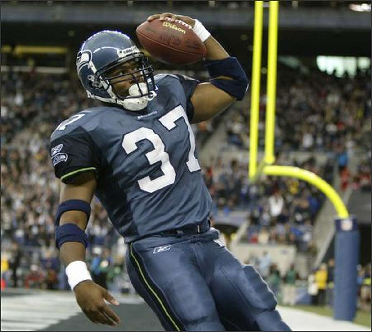 Shaun Alexander goes into his "sprinkler" routine to celebrate his 5-yard touchdown run during the first quarter against the Houston Texans on October 16, 2005. He also scored on runs of 4, 1 and 23 yards.