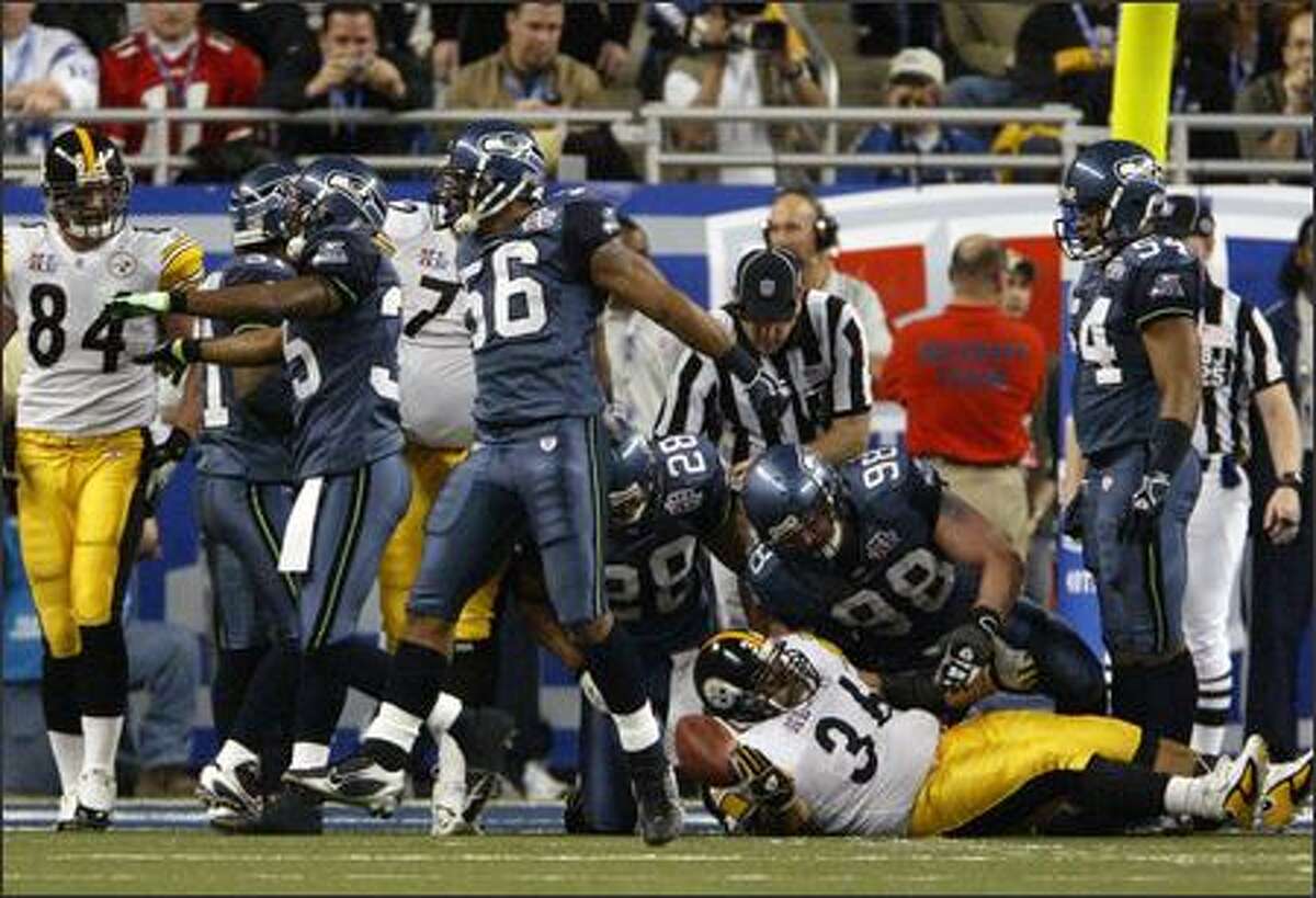 Jerome Bettis (36) is stopped at the Seattle 1 for no gain by Seattle's Leroy Hill (56) while teammates celebrate.