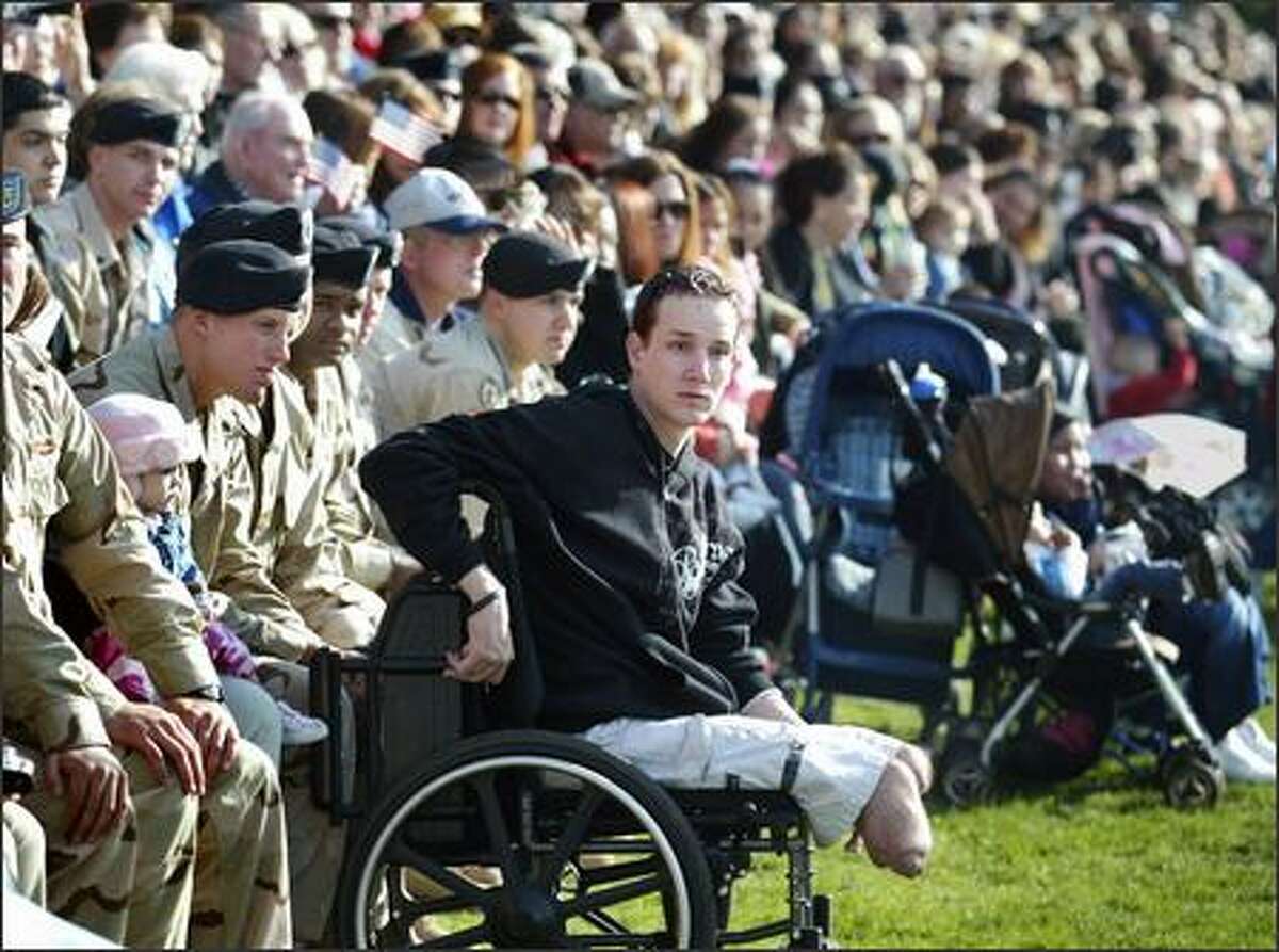 Sgt. Brent Bretz watches the festivities. December 2004, the month Bretz was wounded, was one of the worst of the brigade's deployment, with 10 soldiers killed, including six blow up by a suicide bomber in a mess tent near Mosul on Dec. 21.