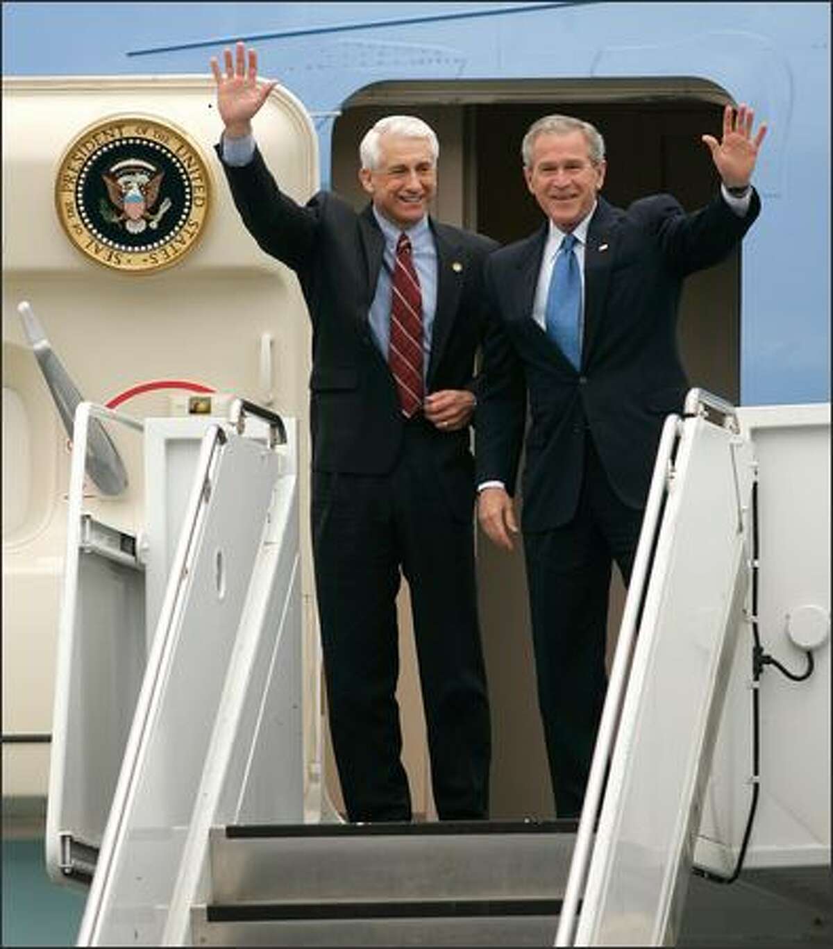 President Bush greets the crowd as he emerges from Air Force One with Rep. Dave Reichert.