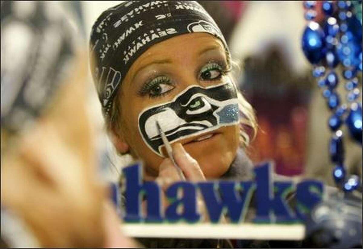 DeDe Schumaier, aka Mrs. Seahawk, starts painting her face at 4 a.m. for a 1 p.m. game against the St. Louis Rams.