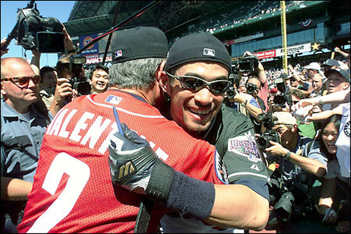 Ichiro gets a hug from National League manager Bobby Valentine during pregame autograph session at Safeco Field.