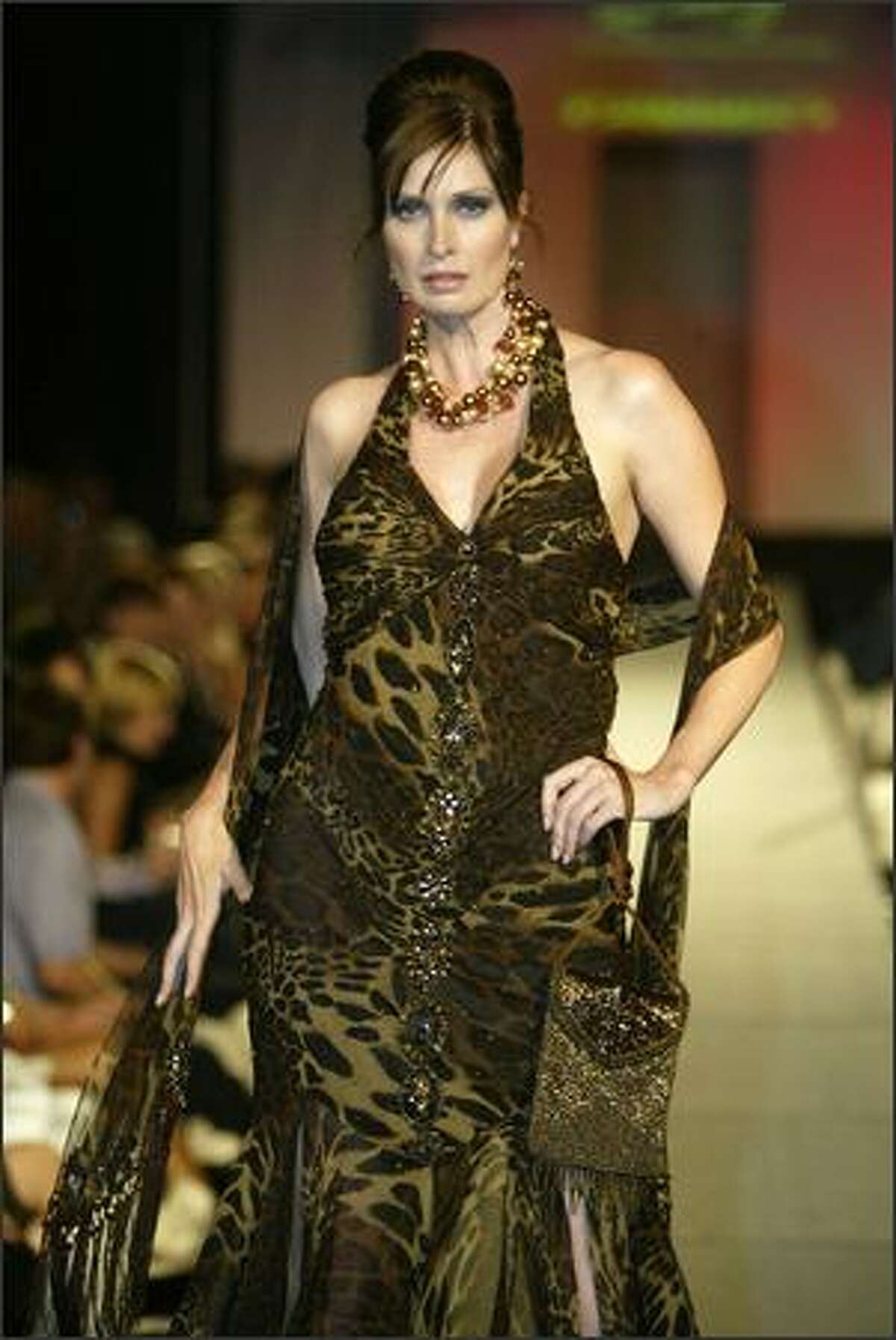 A model shows an outfit from Karan Dannenberg Clothier: Sue Wong Leopard dress, Sue Wong shawl, Susan Marsh copper necklace and shoes by Shoefly at the fall 2006 Fashion First runway show, held at the Premier night club in Sodo on Thursday, Aug. 3.