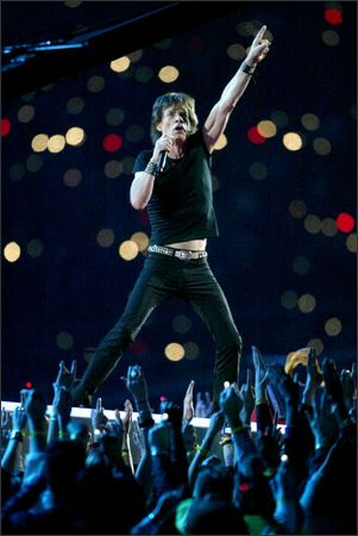 Rolling Stones singer Mick Jagger plays to the halftime crowd.