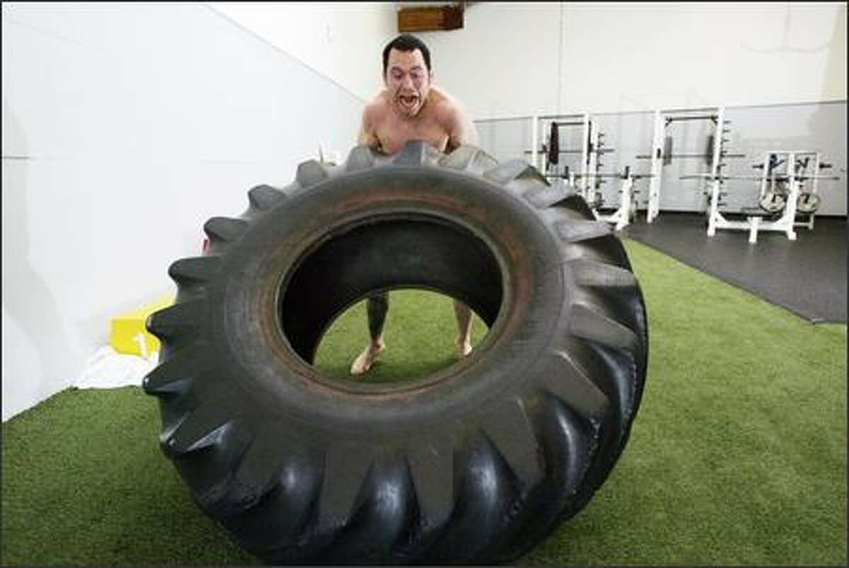 Ultimate fighter Chris Leben conditions using a 300-pound tractor tire in Kirkland.