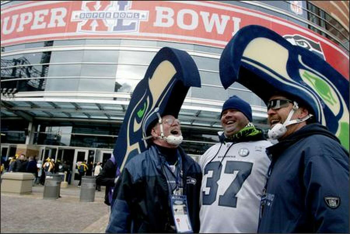 Seahawks fans, from left, Bob McLaughlin, Jared Kline and Jim Kubell show their excitement upon arrival at Ford Field.