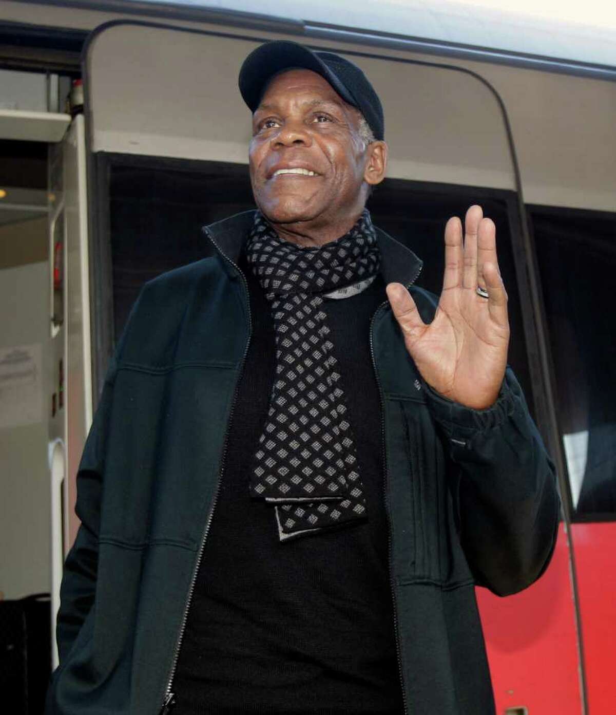 FILE - In this photo taken Friday, Feb. 4, 2011 file photo US actor Danny Glover gestures as he arrives at Rome's main train station. The lawyer of Haiti's Jean-Bertrand Aristide says actor Danny Glover has arrived in South Africa to escort the exiled former president home. Miami lawyer Ira Kurzban flew to Johannesburg Wednesday on the same mission amid unexplained delays as the United States called for Aristide to put off his departure until Sunday's disputed presidential runoff in his homeland. Kurzban says the star of the "Lethal Weapon" action movies arrived Thursday, March 17, 2011. (AP Photo/Pier Paolo Cito, File)