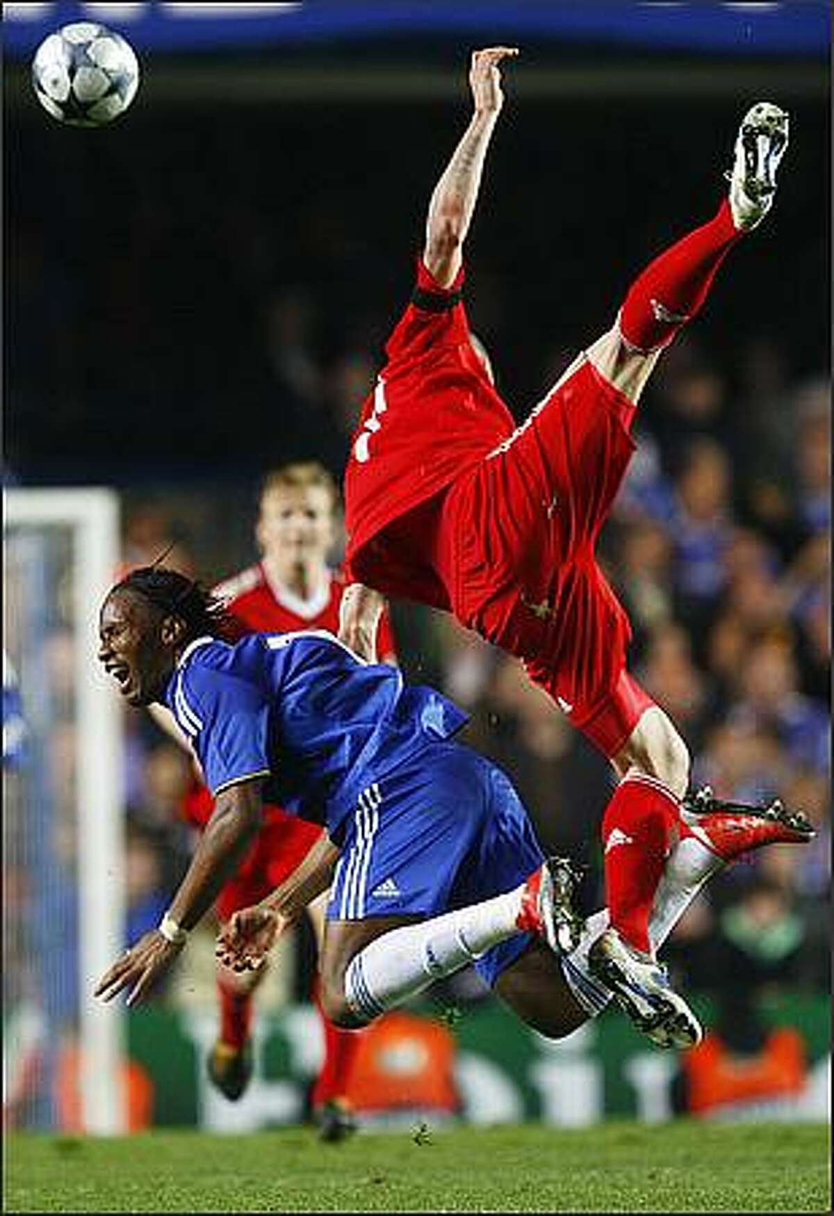 Chelsea's Didier Drogba, left, is fouled by Liverpool's Martin Skrtel during their Champions League quarter-final second-leg soccer match at Stamford Bridge in London on April 14.