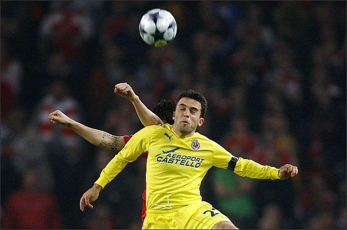 Arsenal's Cesc Fabregas, left, challenges Villarreal's Giuseppe Rossi during their Champions League quarter-final second-leg soccer match at the Emirates stadium in London on April 15.