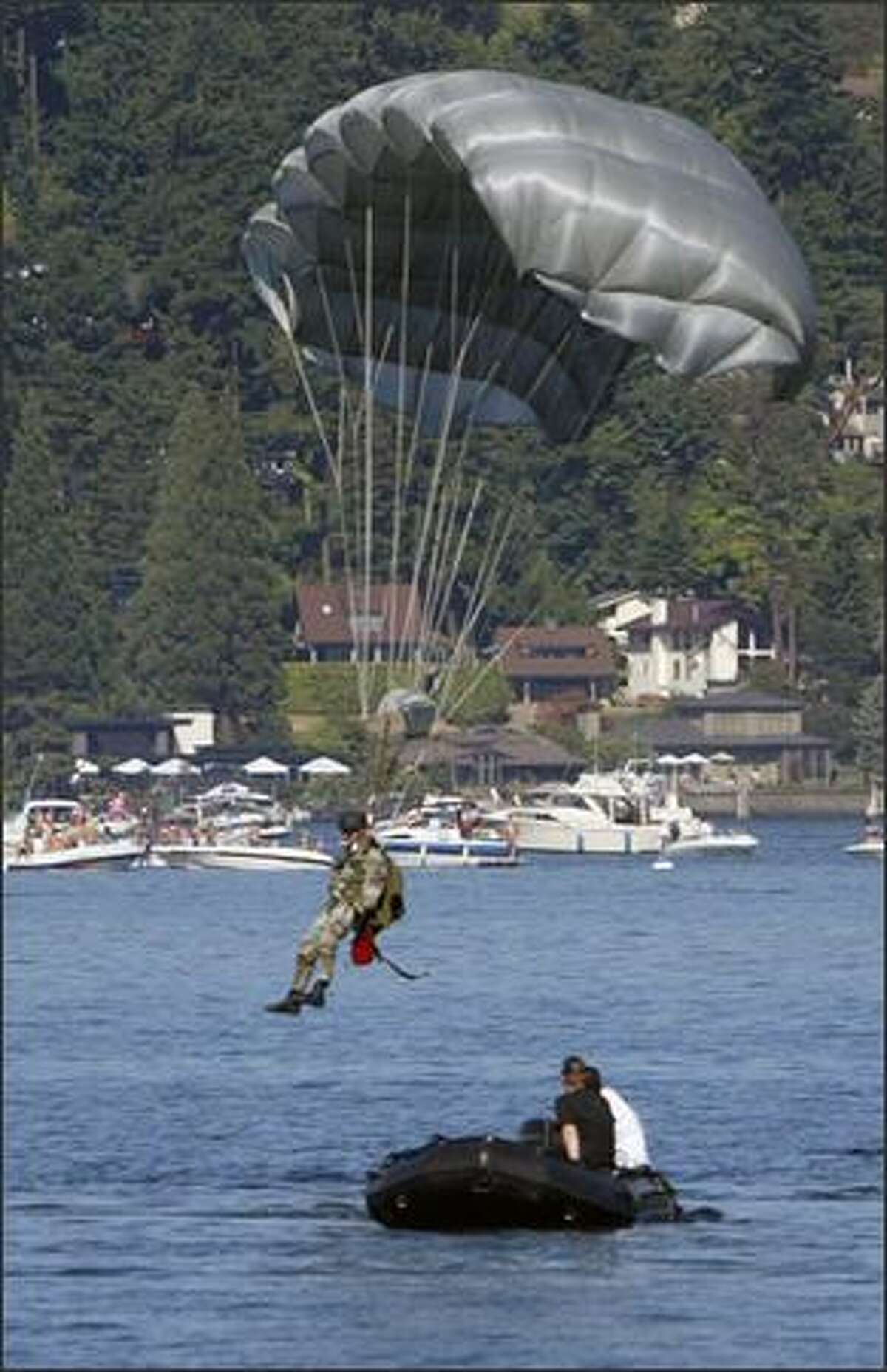 A U.S. Air Force combat controller makes a water landing after jumping from a transport plane over Lake Washington.