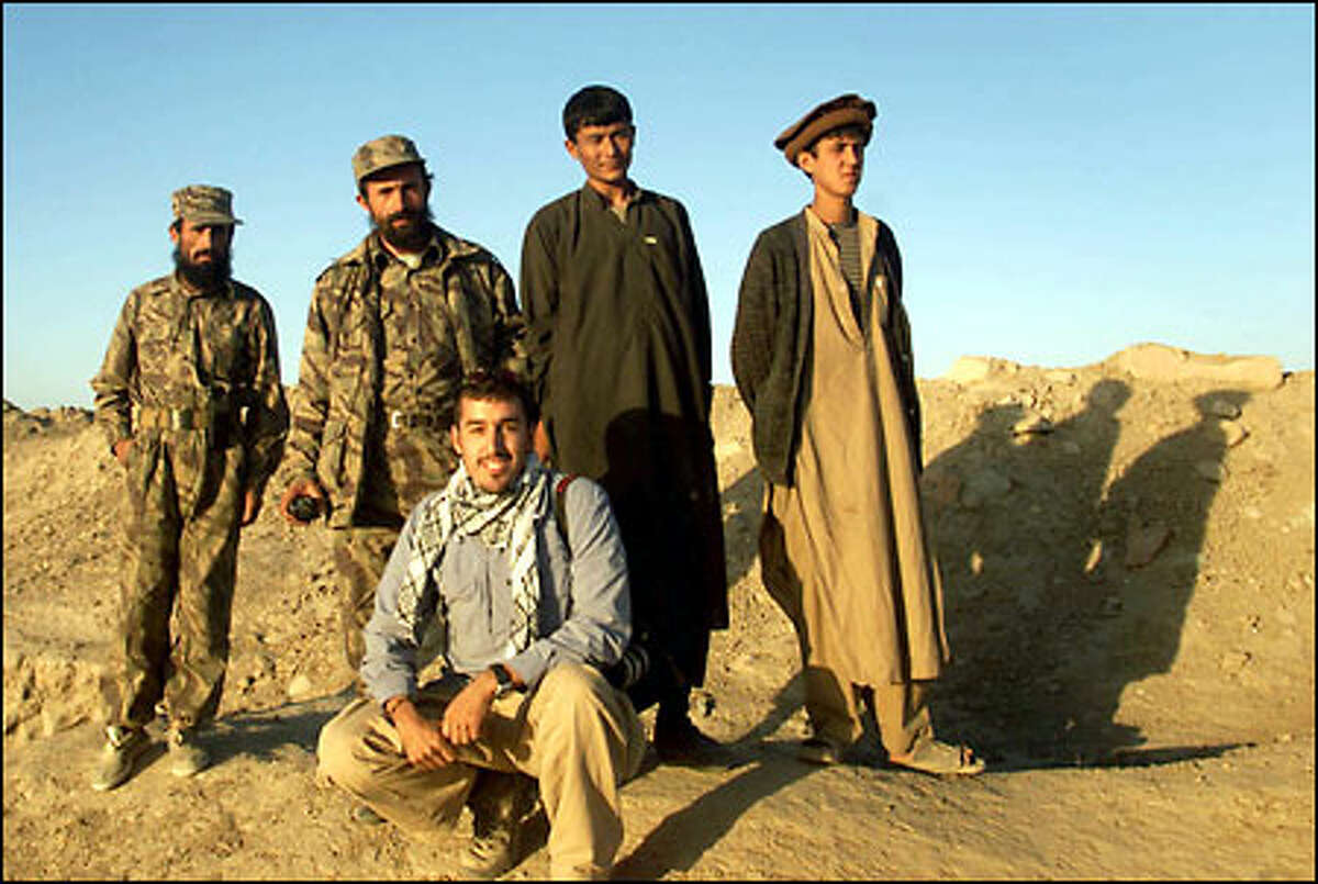 P-I photographer Joshua Trujillo poses with a group of rebels in Afghanistan.