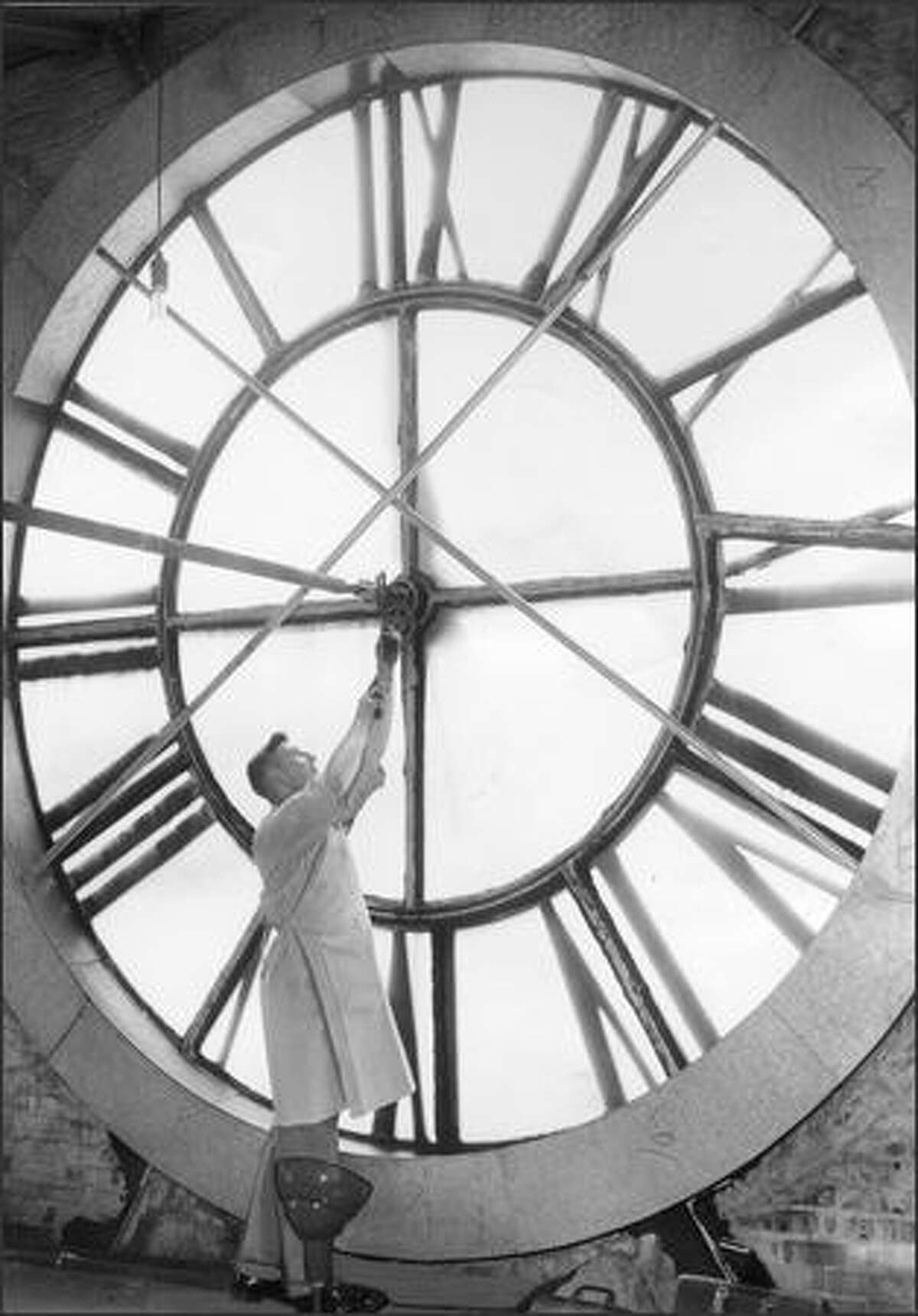 W.L. Wilson of IBM adjusts the clock at King Street Station on May 24, 1957.Many area residents have memories of King Street Station, and they’ll be sharing them in an eight-week celebration of its history that begins at noon Wednesday, May 10, 2006, with a panel discussion in the Bertha Knight Landes Room at Seattle City Hall, 600 Fourth Ave.