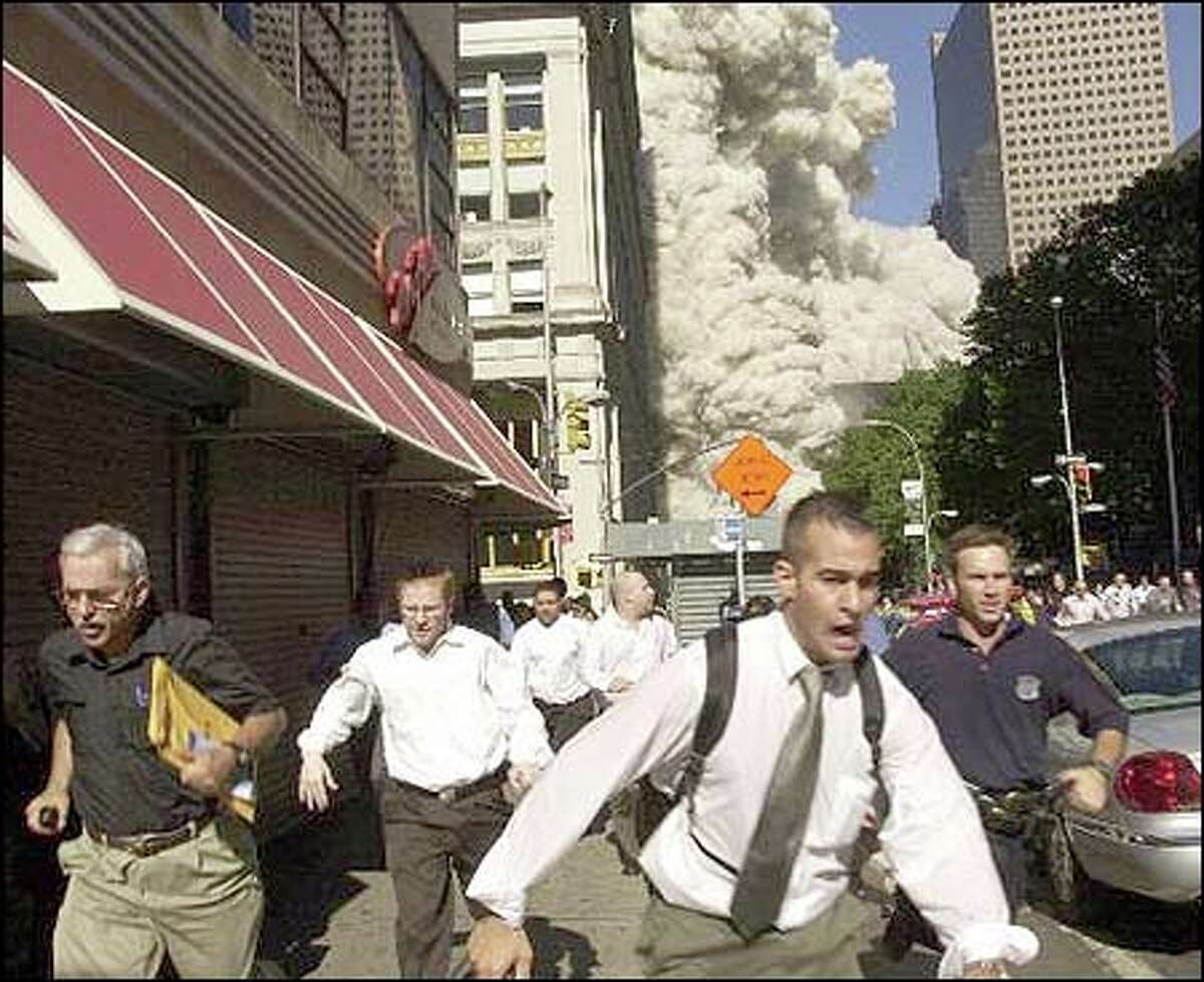 People run from the collapse of the World Trade Center in New York on Sept. 11, 2001.