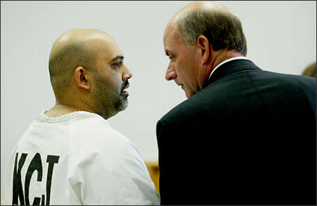 Naveed Haq talks with his attorney C. Wesley Richards during arraignment proceedings at the King County Courthouse in Seattle on Thursday. Haq, who is accused of shooting six people at the Jewish Federation offices, surprised his own attorney by trying to plead guilty.