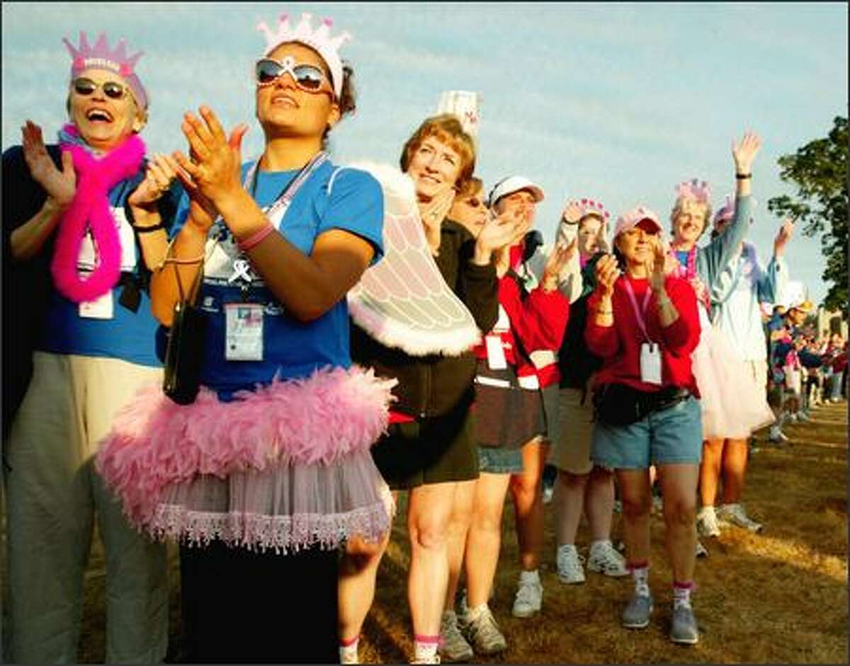 Before beginning their own walk, participants in the Breast Cancer 3-Day, 60-mile fund raiser cheer on the 2,700 walkers as they leave Marymoor Park on Friday.