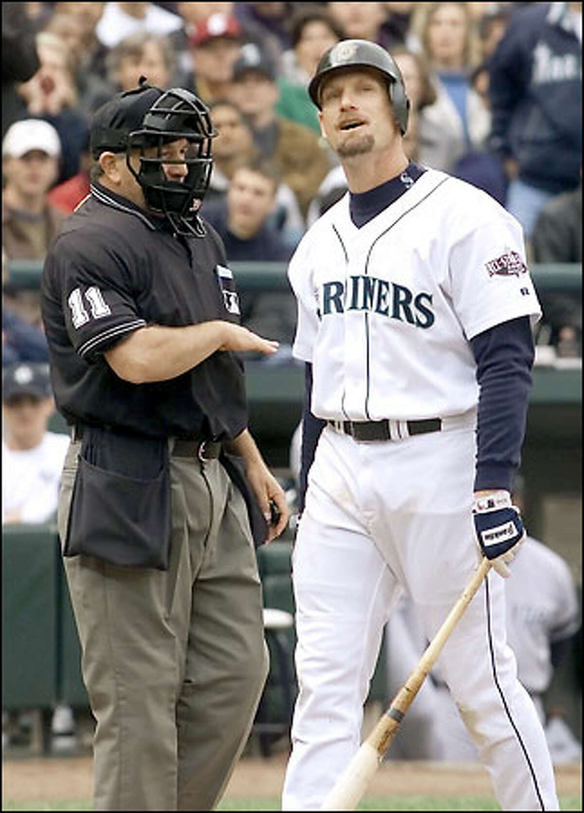 Jay Buhner strikes out and objects to the call as umpire Ed Montague shows him where it was in the ALCS Game 1, Oct. 17, 2001.