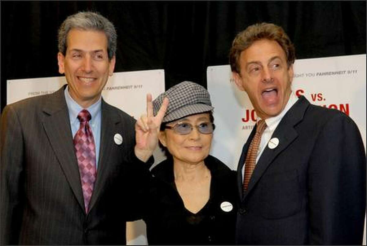 Yoko Ono Lennon poses with filmmakers David Leaf, left, and John Scheinfeld after talking about their new film "The U.S. vs. John Lennon" during a press conference at The Regency Hotel Wednesday in New York. The ex-Beatle's celebrated battle with the feds is chronicled in documentary, which traces how he went from rock star to fierce anti-war protester to "undesirable alien." The documentary played at the Toronto Film Festival in advance of its theatrical debut Friday. (AP Photo/Paul Hawthorne)