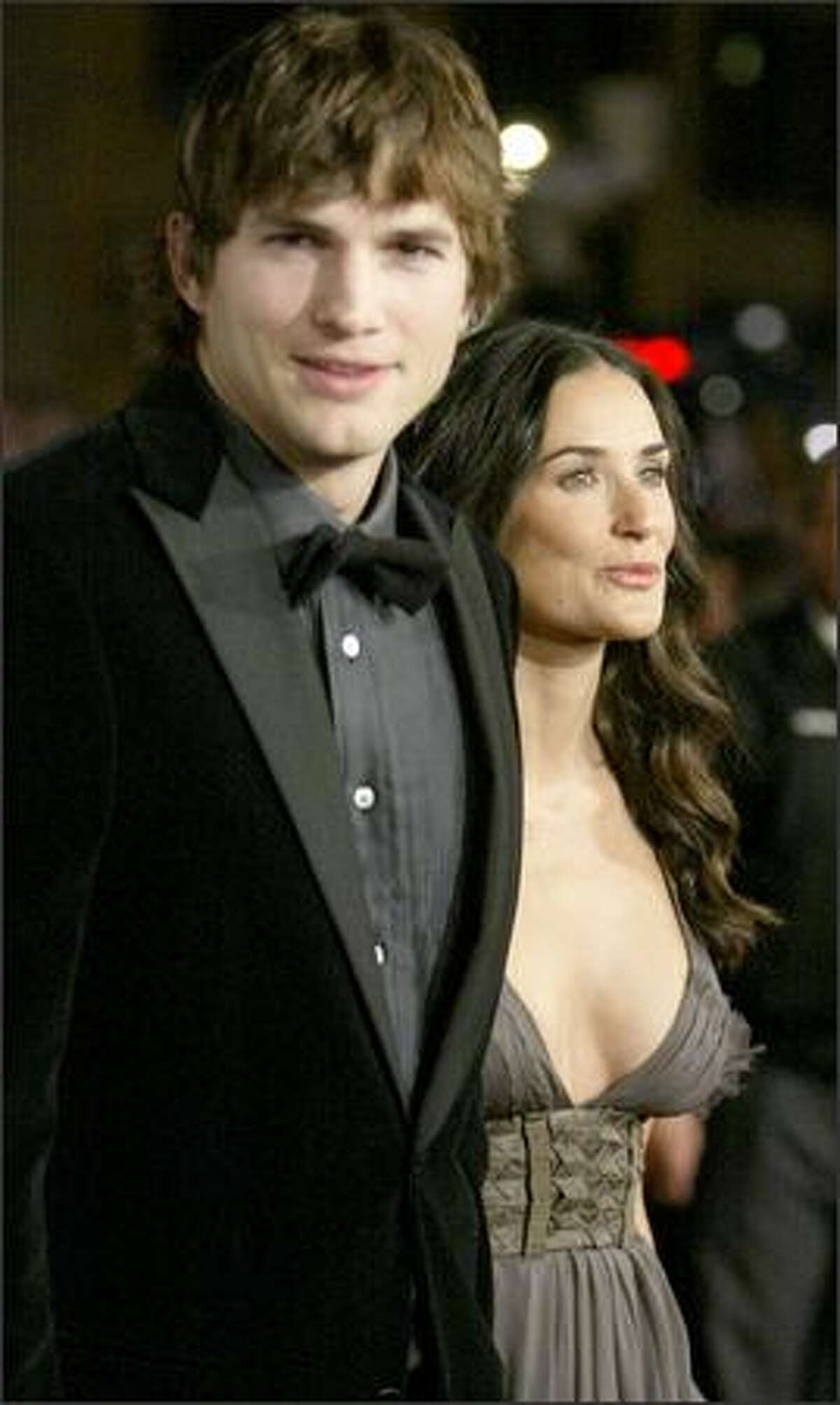 Ashton Kutcher, left, and Demi Moore, right, arrive for the premiere of the movie "Bobby" during the opening night of AFI Fest 2006, Wednesday in Los Angeles. (AP Photo/Danny Moloshok)