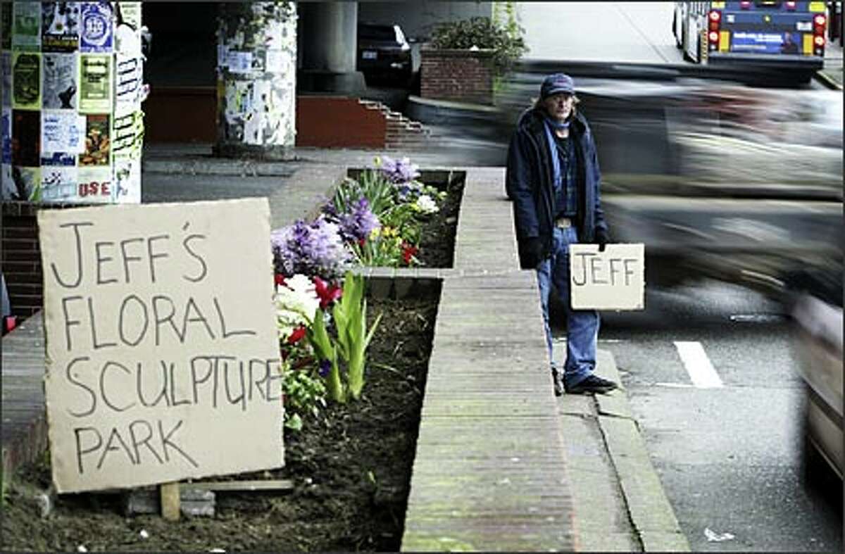 On most days, Jeff Alexander can be found panhandling by the Ballard Bridge while his wife, who has epilepsy, rests in their truck. Alexander, 53, an unemployed commercial fisherman, said he loves to garden, so he started cultivating the old brick planters that line the street. He says it's his way of thanking Ballard residents.Arias: I had just finished an assignment and was looking for a place to have lunch when I made this photo. I don't know why I decided to go by here; it's not one of my usual routes. But I'm sure glad I did.