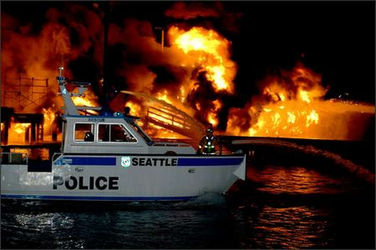 Towering flames light up the night sky from a massive fire on Lake Union. Emergency crews received the call at 1:28 a.m., said Helen Fitzpatrick, Seattle Fire Department spokeswoman.