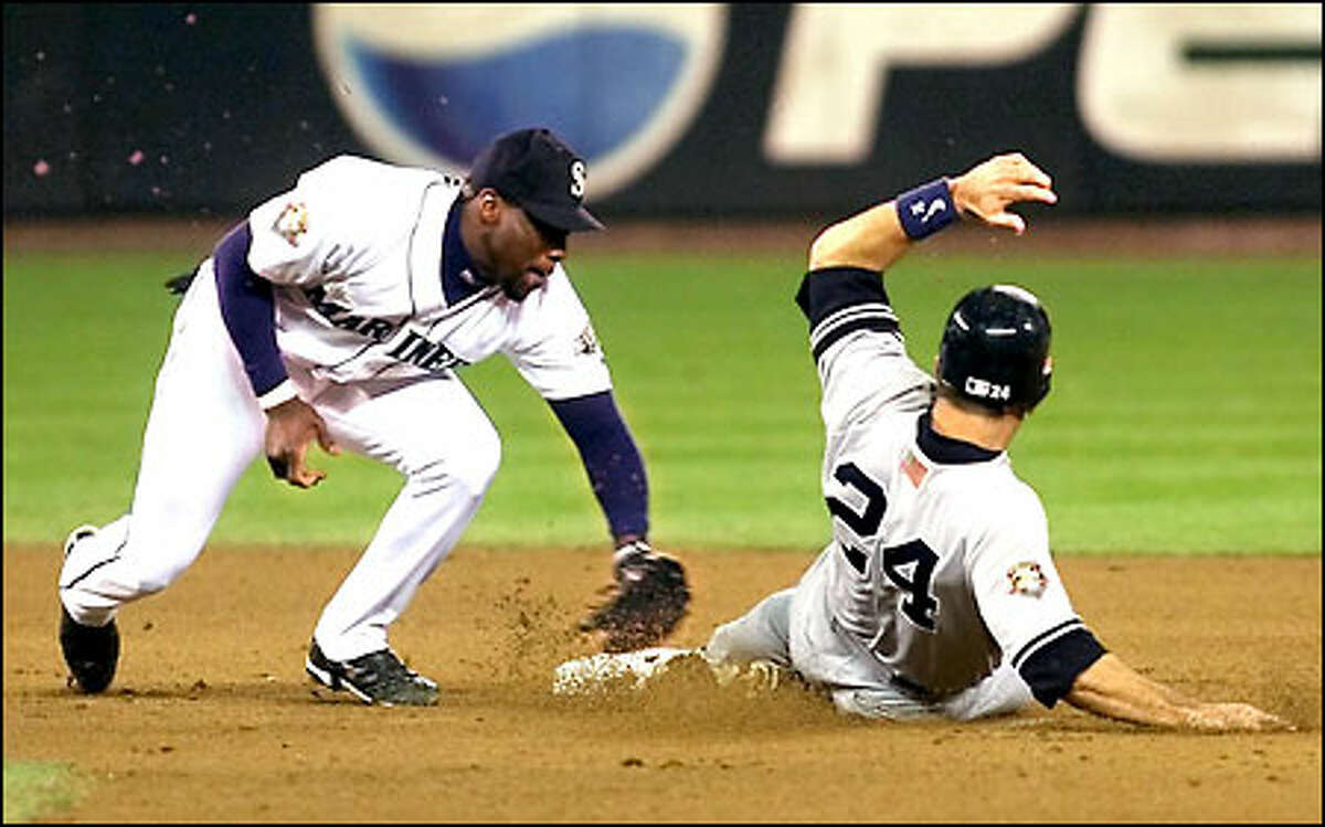 Mark McLemore takes out Yankees Tino Martinez in the 6th inning.