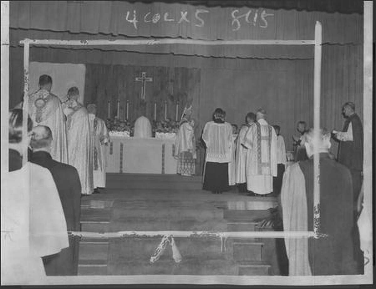 Before a crowd in the St. Edward's Seminary gymnasium, the Most Rev. Thomas A. Connolly, Archbisho of Seattle, pontificates at high mass on October 21, 1956.