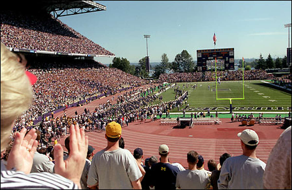 Led by quarterback Cody Pickett, the UW football team files into Husky Stadium to begin its 2001 season.