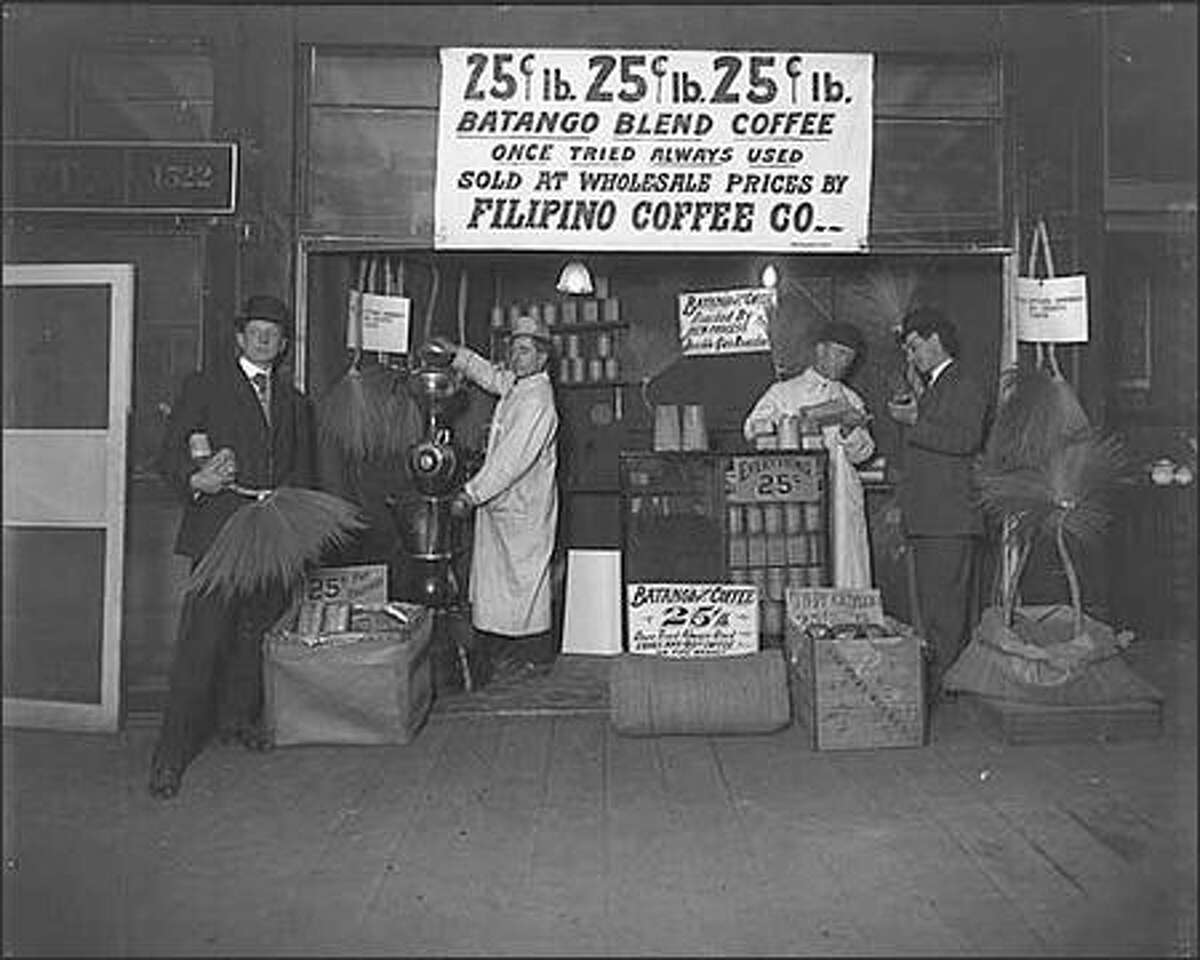 The address number 1522 on the wall behind this coffee display indicates the photo was taken in the Pike Place Market ca. 1909.
