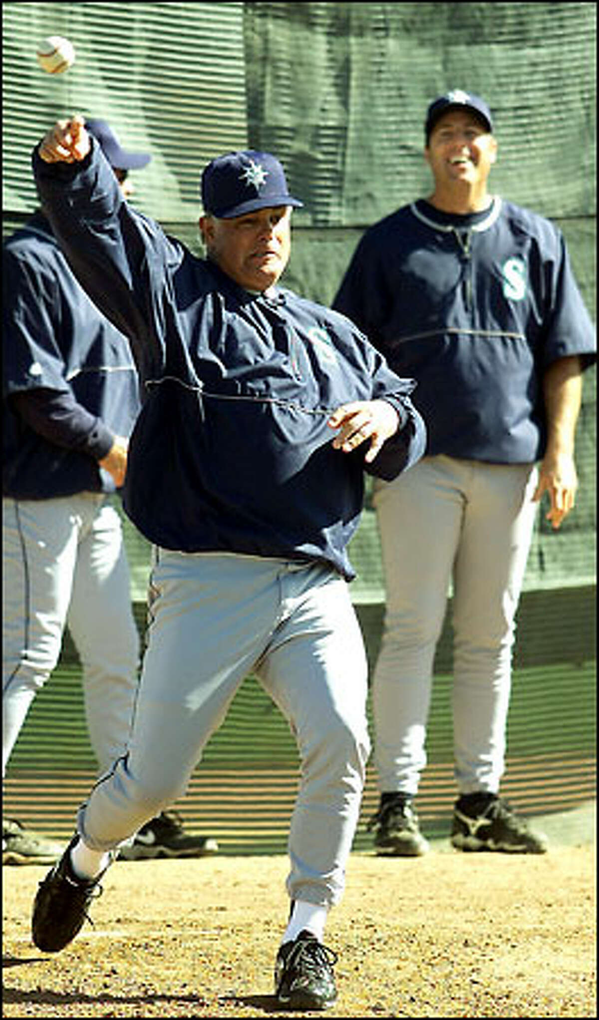 Lou Piniella shows off his pitching form, as pitching coach Bryan Price gets a good laugh.