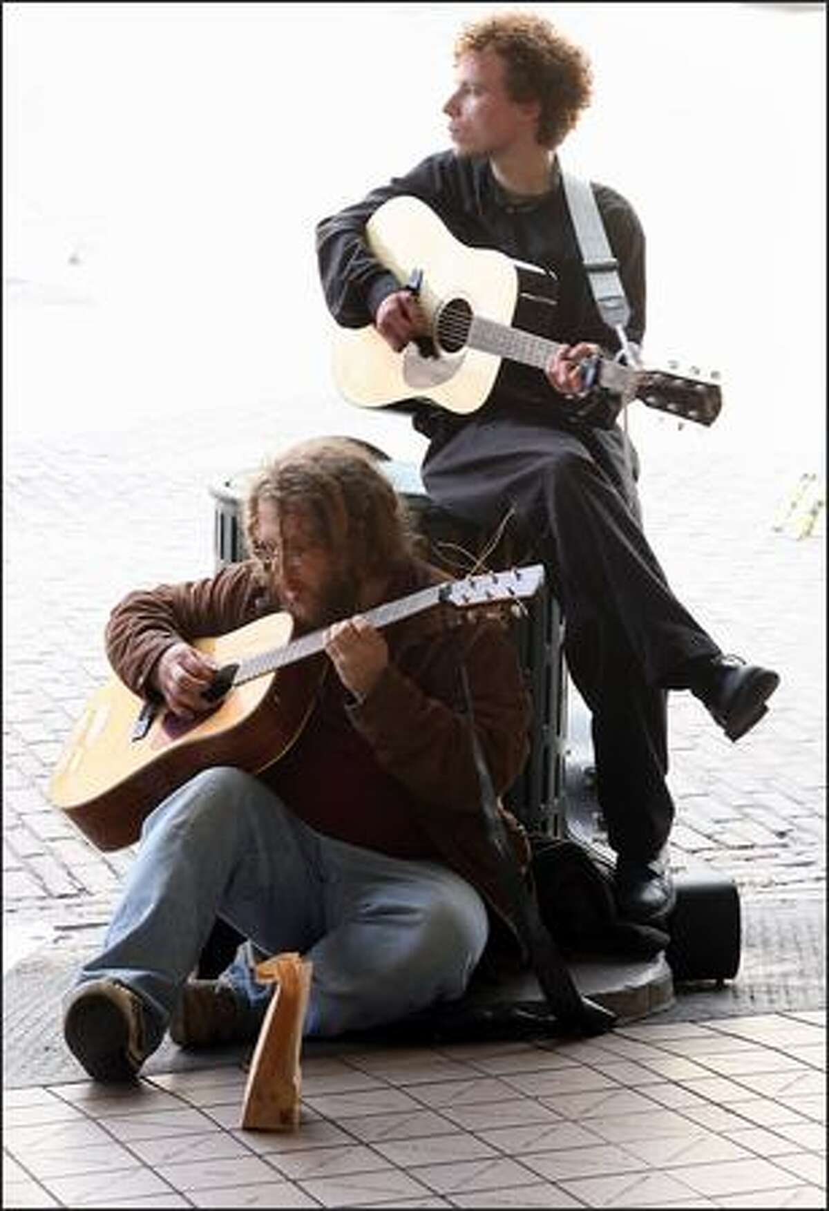 Street musicians Tommy Dean and Kind Kieth perfom at the Pike Place Market.