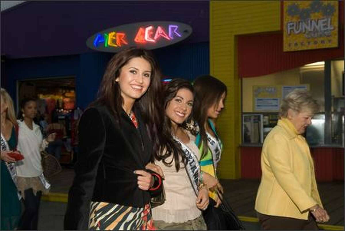 Alla Ilushka, Miss Minnesota USA 2007, Nicole Bosso, Miss Delaware USA 2007, and Helen Salas, Miss Nevada USA 2007, walk down the Santa Monica Pier in Santa Monica, Calif., on March 13.