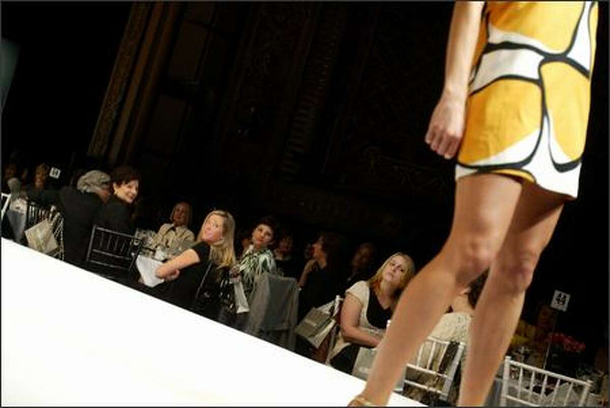 A model displays a marigold giant-stone-print "Damita" shift dress.