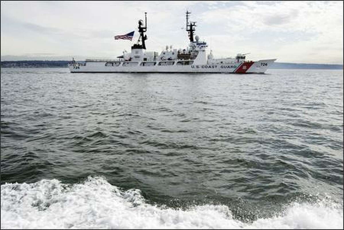 The U.S. Coast Guard Cutter Midgett races towards its homeport of Pier 36 in Seattle Friday, March 16, 2007. The 378-foot cutter is completing a six month deployment that included extensive anti-piracy, maritime security and interdiction operations in the Middle East with coalition forces. Midgett then embarked on a global circumnavigation to return to Seattle.