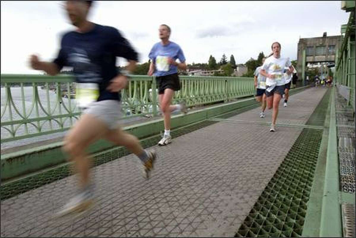 Runners head across the University Bridge during the 25th Nordstrom "Beat the Bridge to Beat Diabetes" race on Sunday. More than 9,000 participants took part in the event, which started and ended at Husky Stadium. The goal of many in the 8K race was to cross the bridge, at the 2-mile mark, before it was raised for 20 minutes.