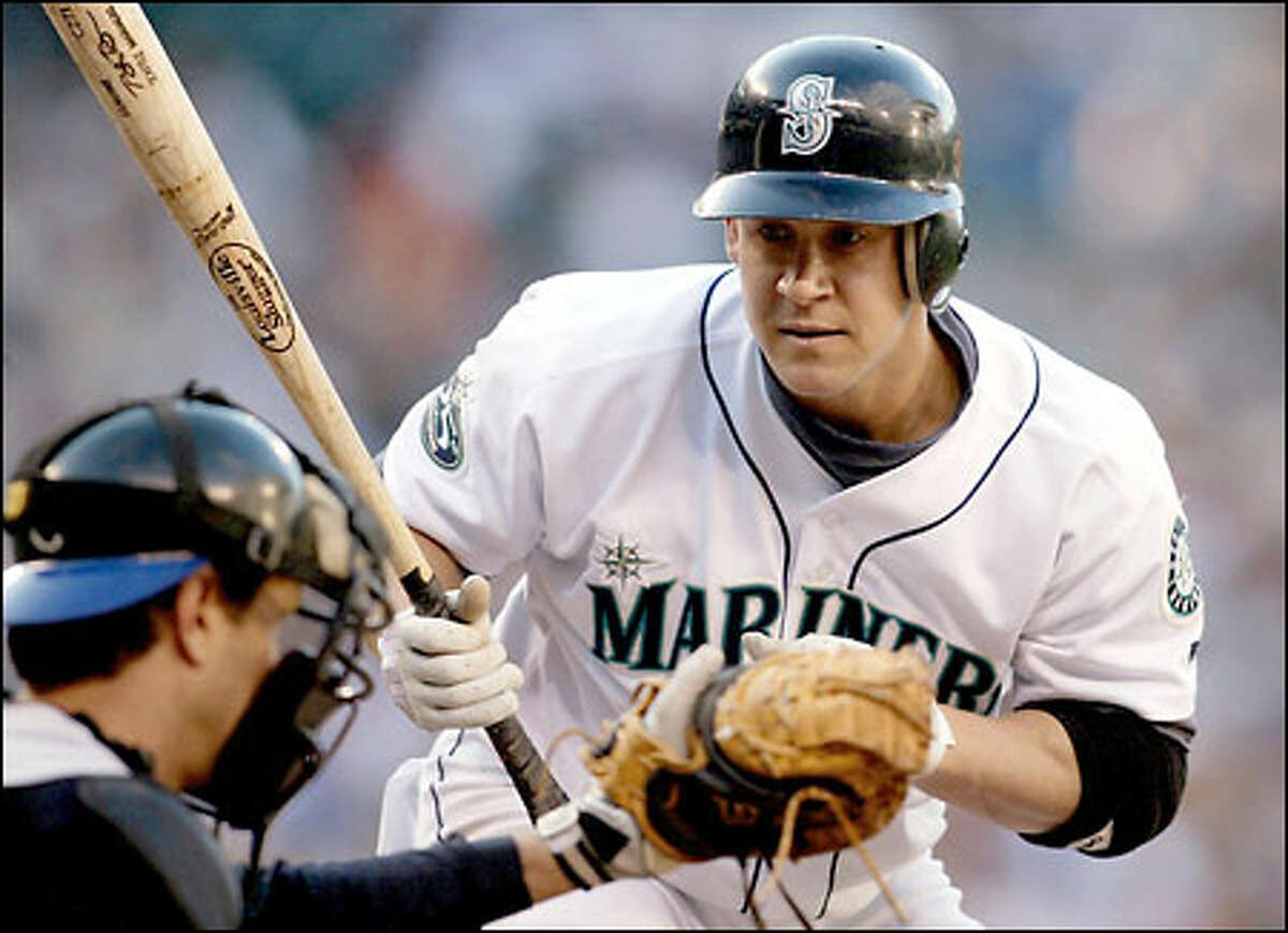 Bret Boone watches Royals' catcher Brent Mayne catch the ball just before hitting a home run in the second inning.