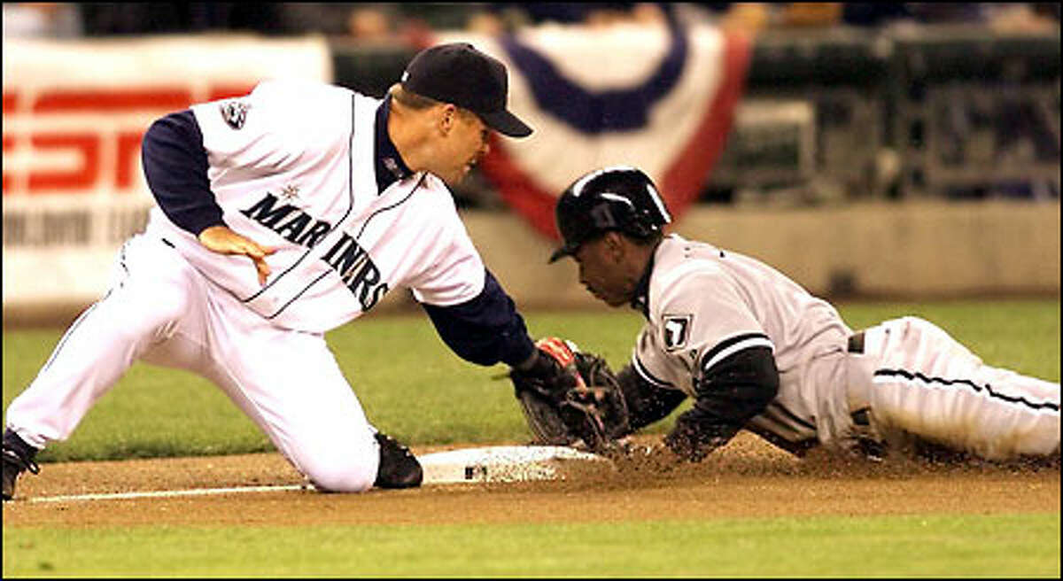 Kenny Lofton steals third as Jeff Cirillo attempts the tag in the first inning. Lofton scored on the next play, putting the Sox up 1-0.