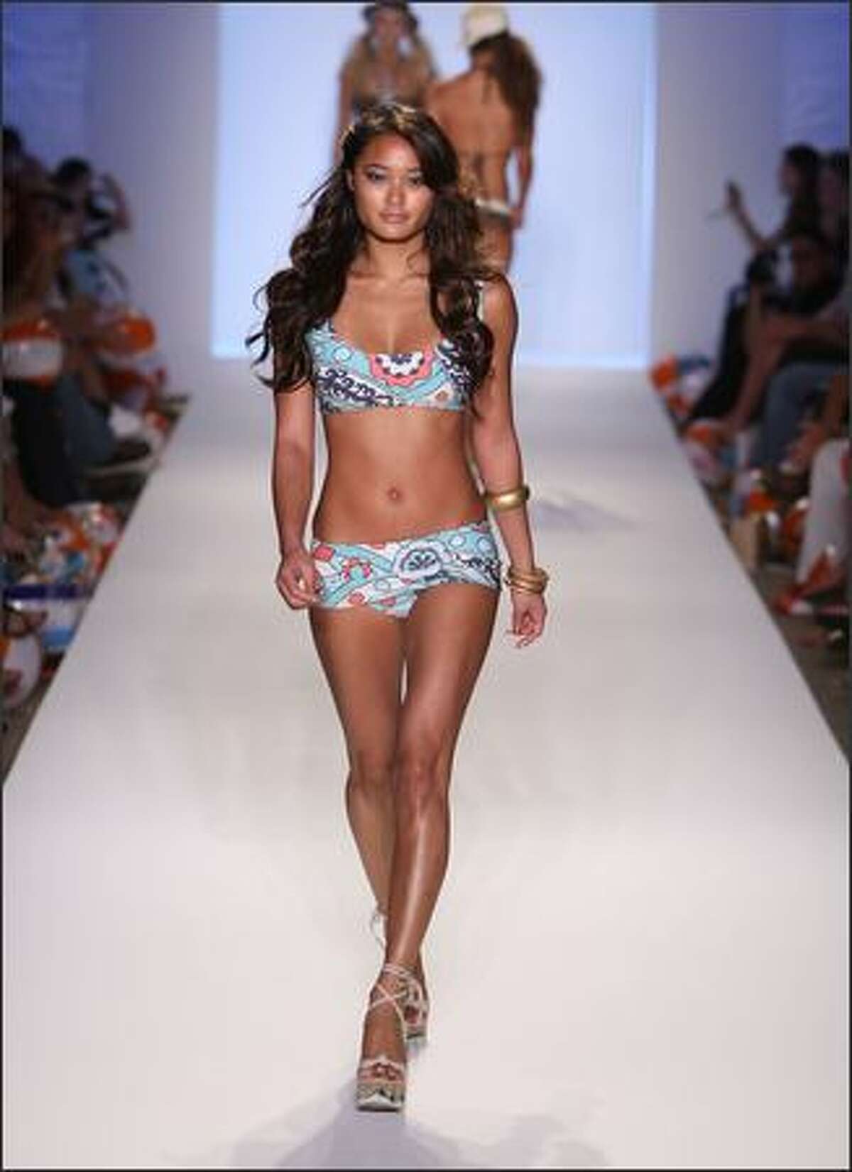 MIAMI BEACH, FL - JULY 13: A model walks down the runway at the Ashley Paige swimwear fashion show during "Mercedes Benz Fashion Week: Miami Swim" in the Cabana Grande tent at the Raleigh Hotel on July 13, 2007 in Miami Beach. (Photo by Mark Mainz/Getty Images for Ashley Paige)