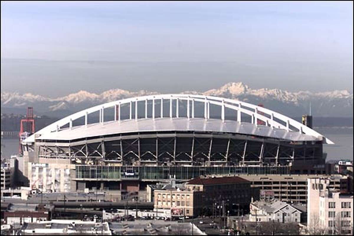 The stadium's white "rainbow" roof fills the vacancy on Seattle's skyline opened by the Kingdome's implosion. A graceful steel bow truss recalls the arc of a long pass.