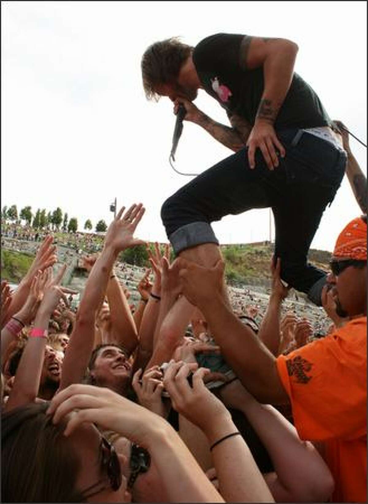 Craig Owens of Chiodos walks over a sea of raised hands at the Vans Warped Tour held at the Gorge Amphitheatre in George, Wash. Saturday, August 18, 2007.