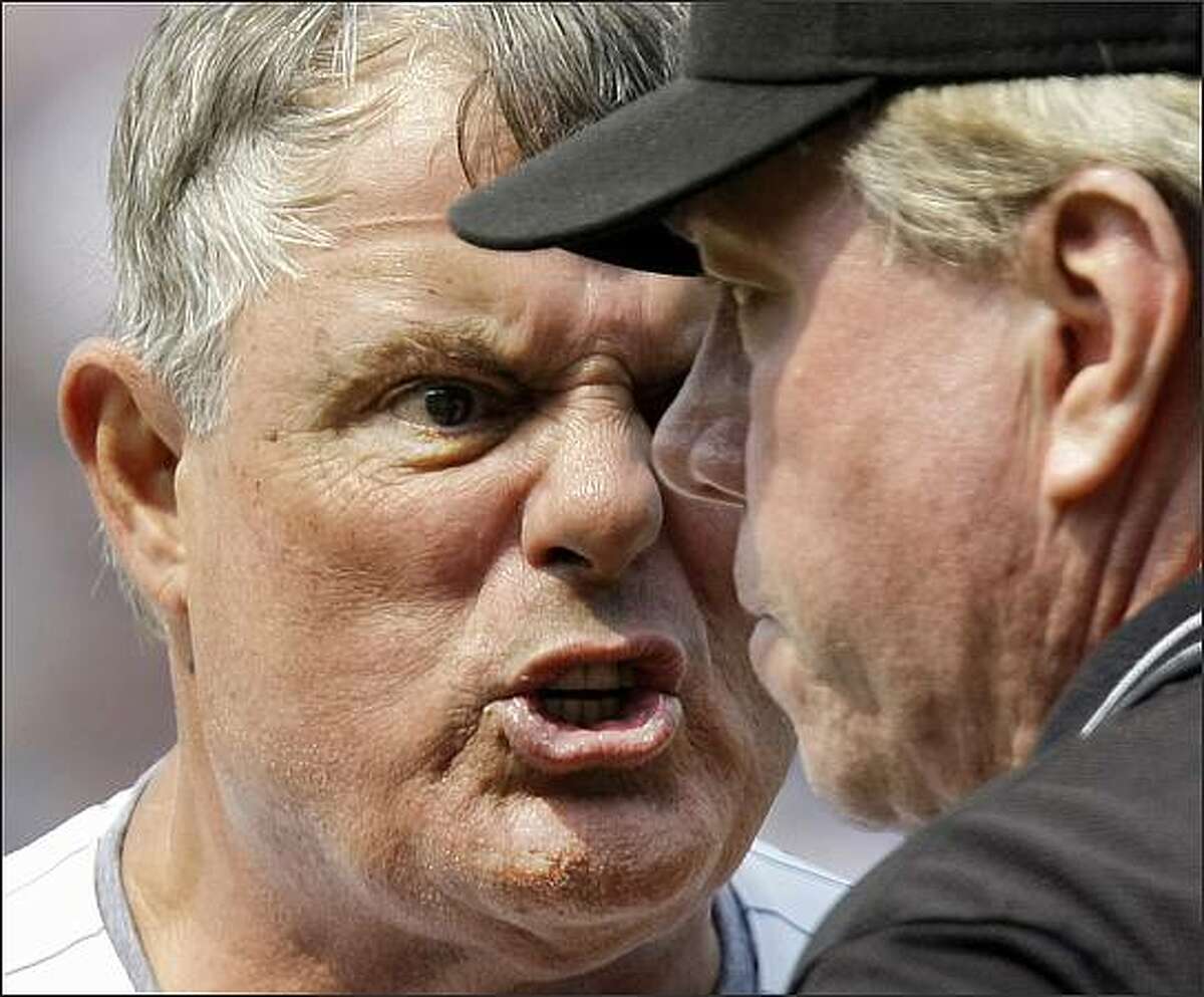 Chicago Cubs manager Lou Piniella, left, argues with third base umpire Brian Gorman, right, after first base umpire Rob Drake ejected Piniella during the ninth inning of their baseball game against the Florida Marlins at Wrigley Field in Chicago. (AP Photo/Charles Rex Arbogast)