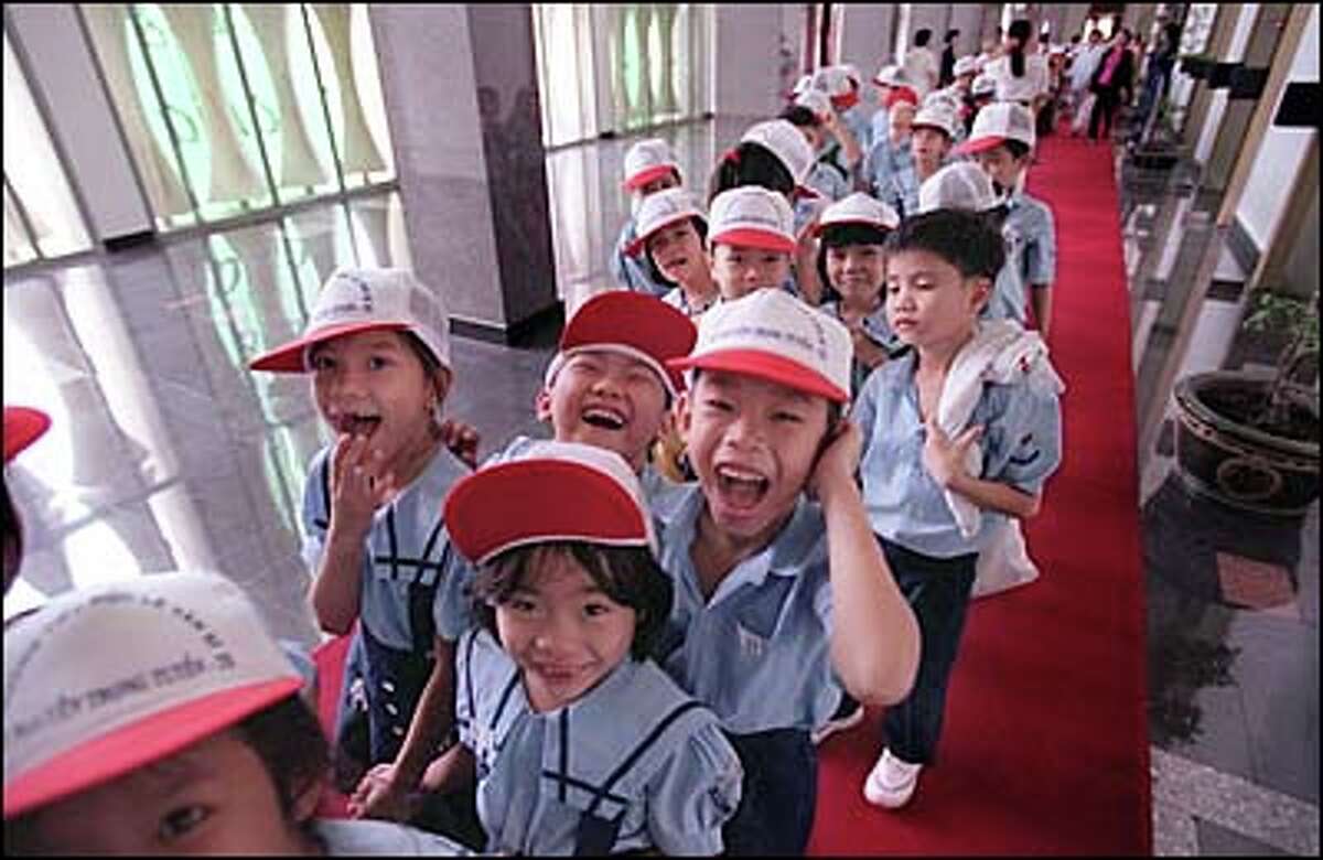 Ho Chi Minh City grade school children touring the Reunification Palace. Formerly known as Independence Place, it was the center of the government of South Vietnam during the Vietnam War, housing the President's office and the war command room which have been kept as they were when North Vietnamese tanks rolled onto the grounds April 30, 1975.