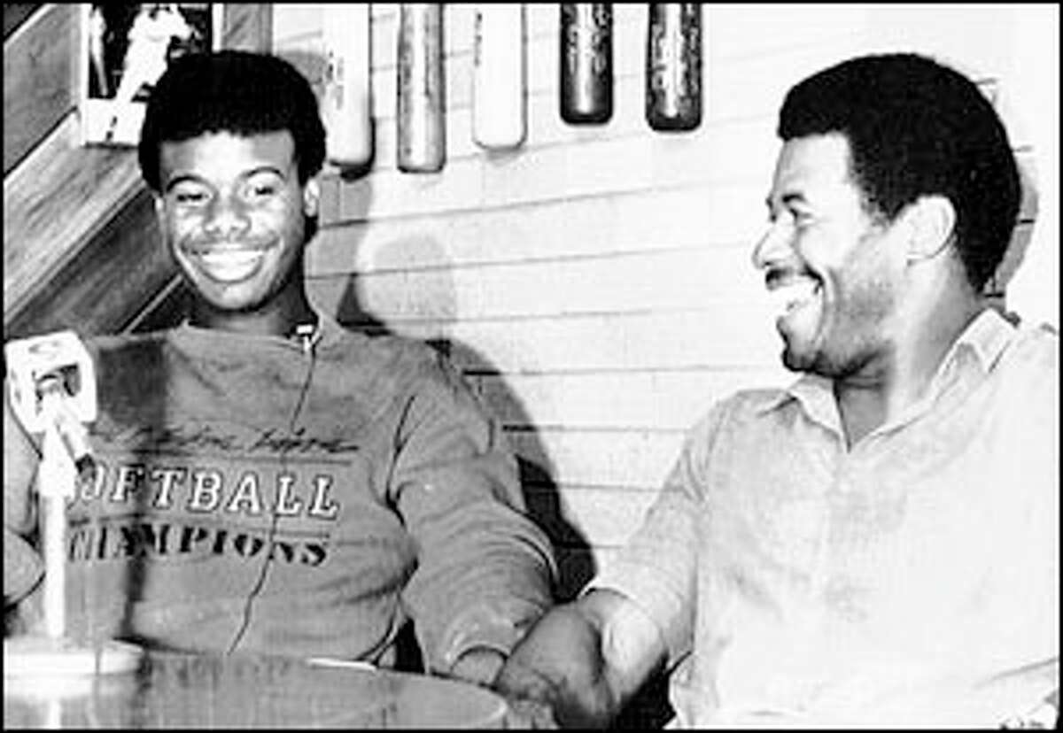 Ken Griffey Jr. sits with his father, Ken Griffey Sr., at a press conference after Junior was drafted by the Mariners.