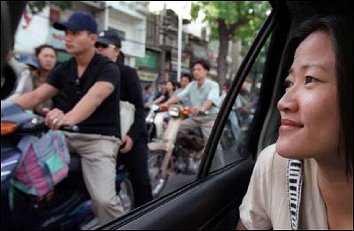 The streets along which Phuong Le's family fled from its home in Saigon in 1975 are clogged now with motorcycles from dawn until late at night.