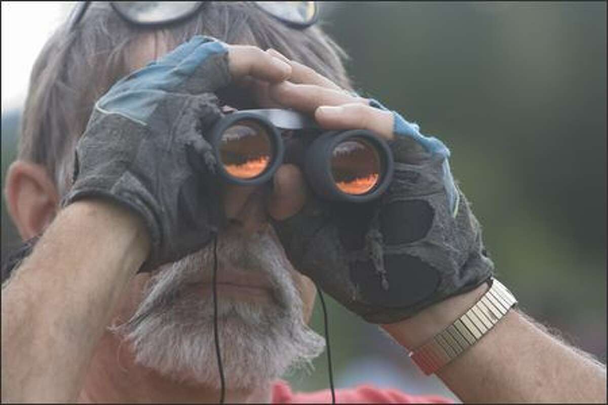 Bill Sokolick uses his binoculars to see the action on the 10th hole at the 2007 Boeing Classic, TPC Snoqualmie Ridge. Dennis Watson won the $240,000 first place check after defeating six other golfers in two playoff rounds on the 18th hole Sunday, August 26, 2007. Snoqualmie, WA.