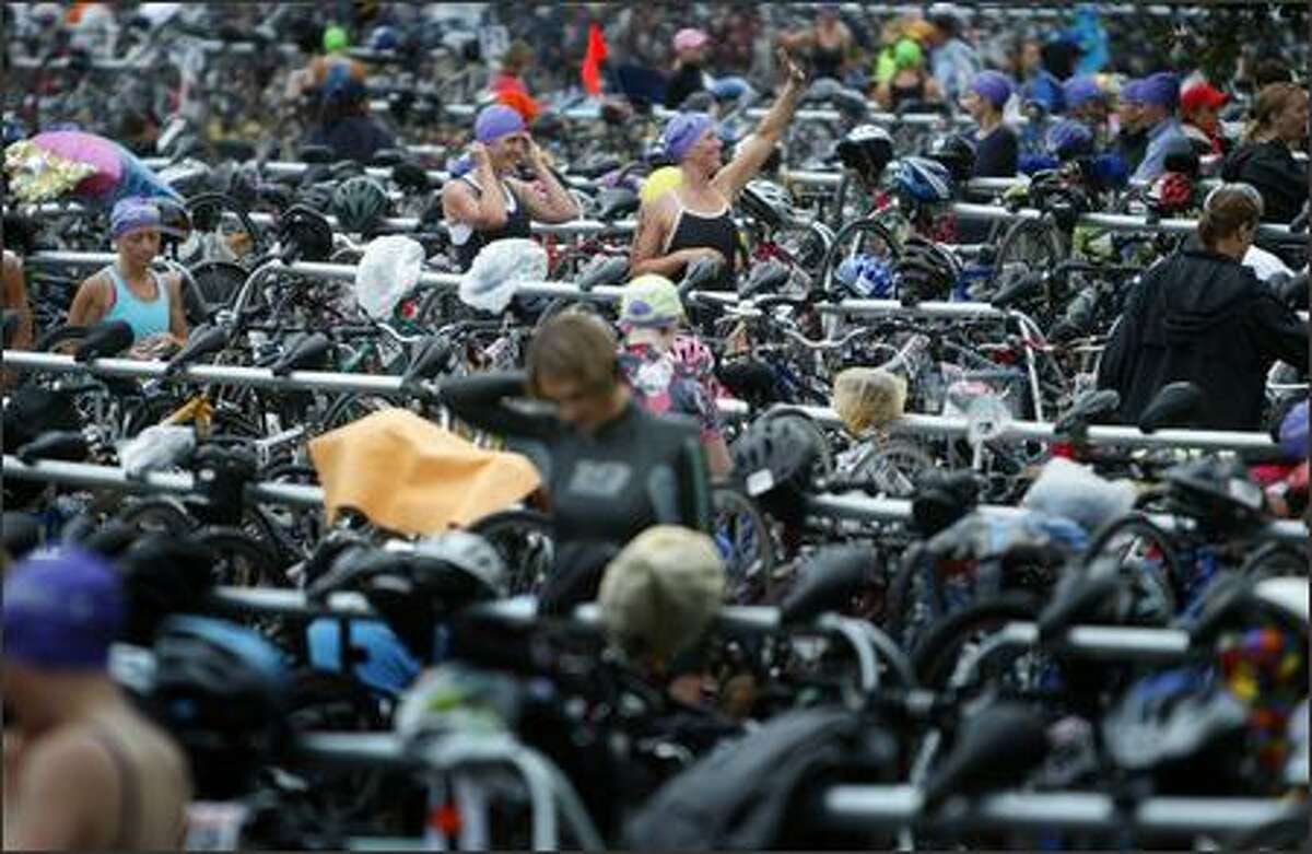 Danskin Women's Triathlon participants wander through a sea of bicycles and equipment.