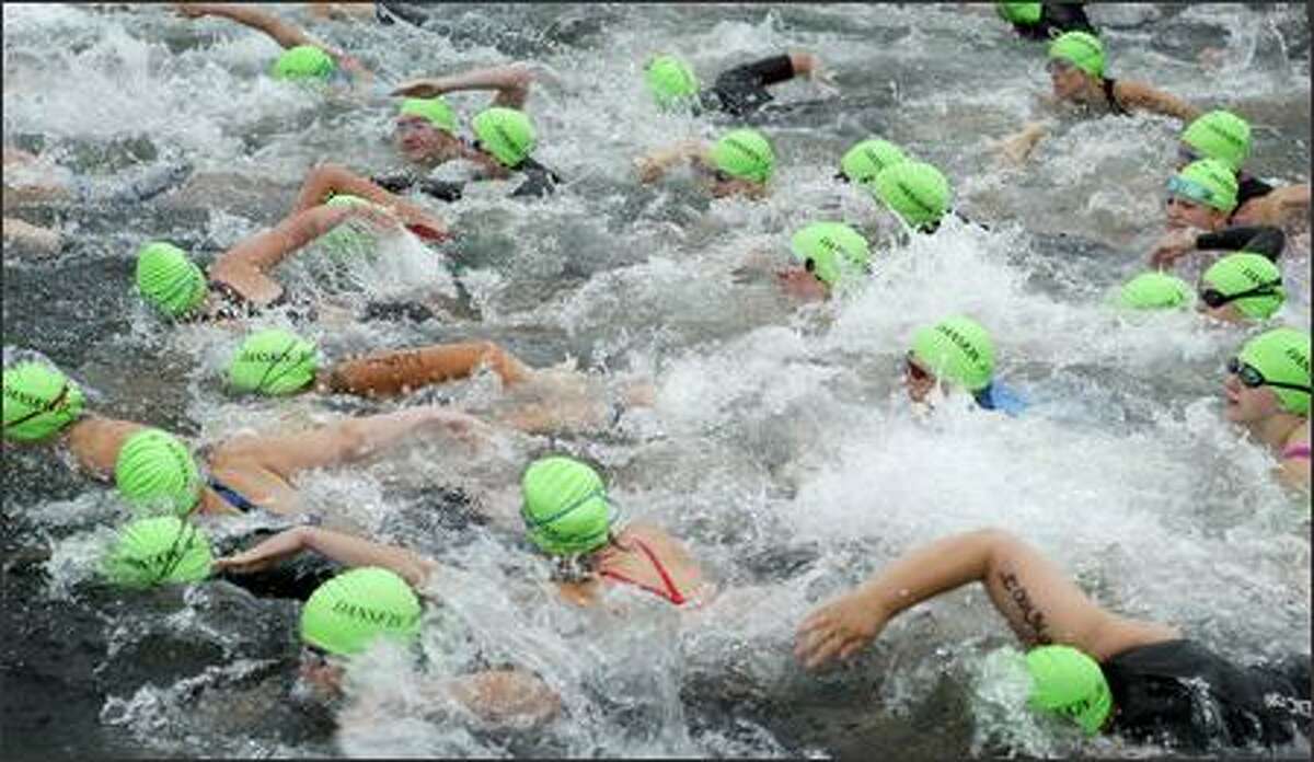 Danskin Women's Triathlon participants take the plunge into Lake Washington at Genesee Park in Seattle.