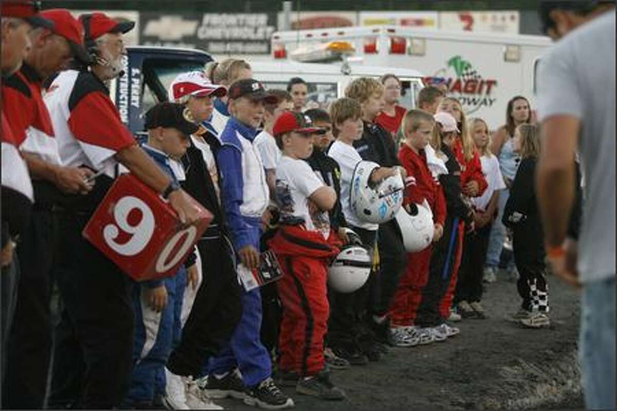 Kasey Kahne Junior Sprint drivers from Demming Speedway line up to listen to Kahne address the crowd at Skagit Speedway on Wednesday night.